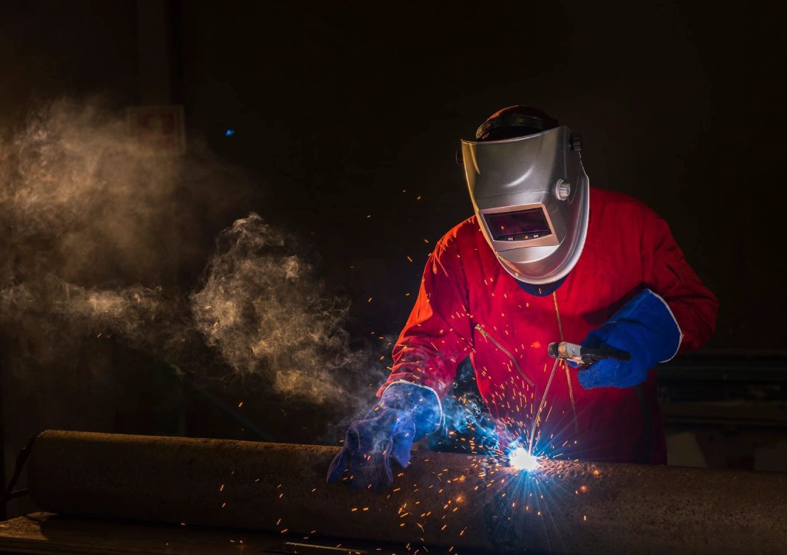 A man welding with an electric arc.