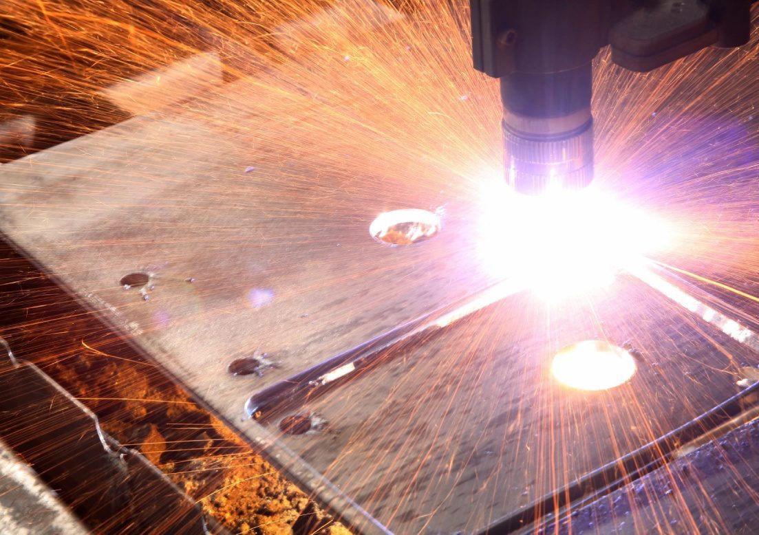 A person is welding on the table.